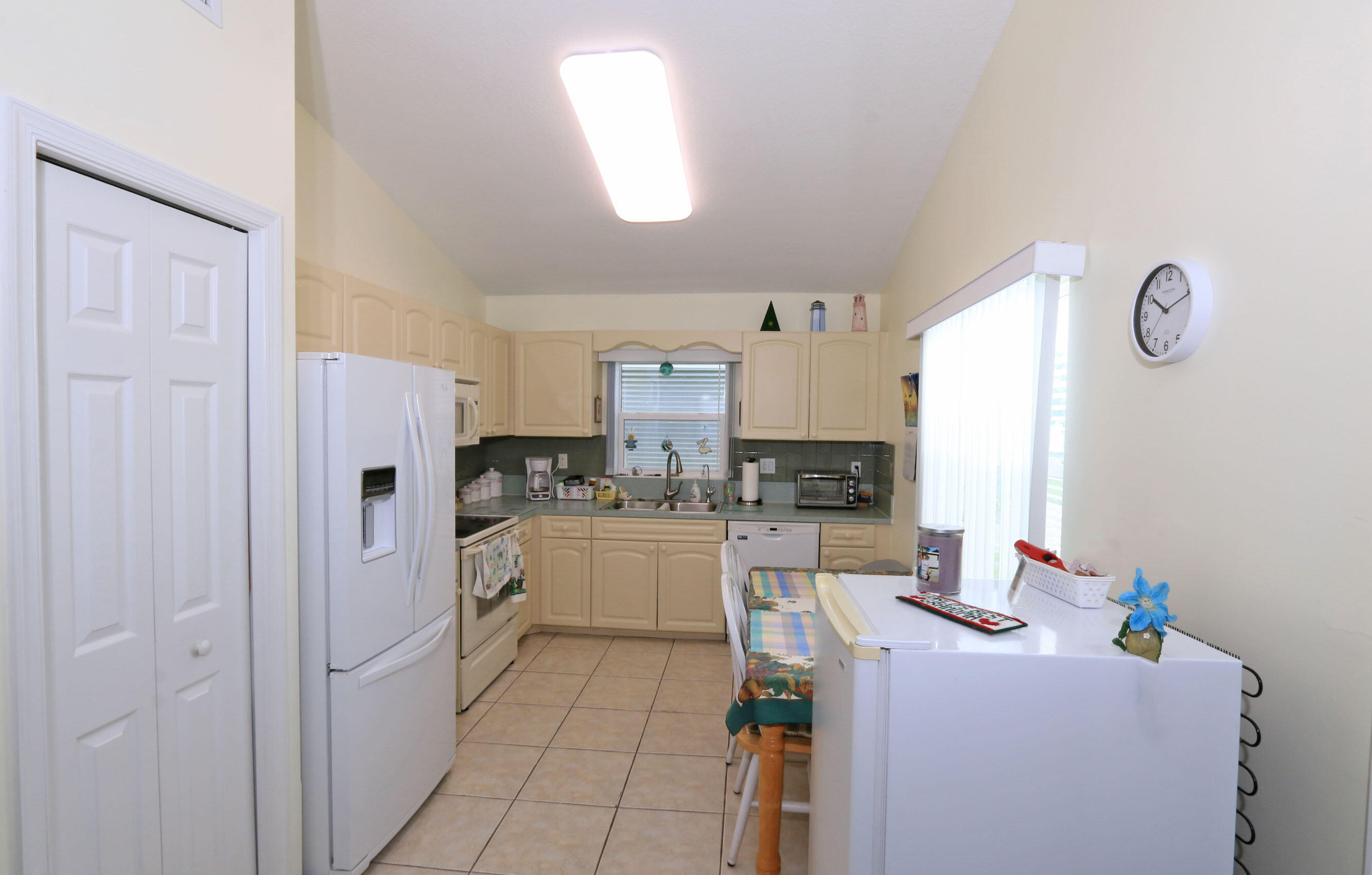 4350 Southwest 9th Way Okeechobee, FL 34974 - Photo 10 of 52 a room with a refrigerator and a stove top oven