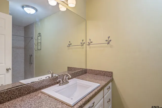 an empty room with a ceiling fan and a window