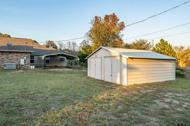 a view of a house with a backyard