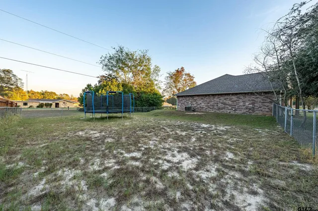 a view of a house with a yard and potted plants