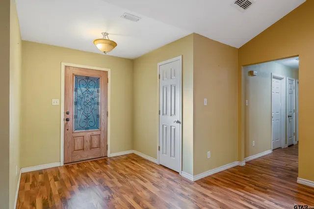 a view of hallway with wooden floor