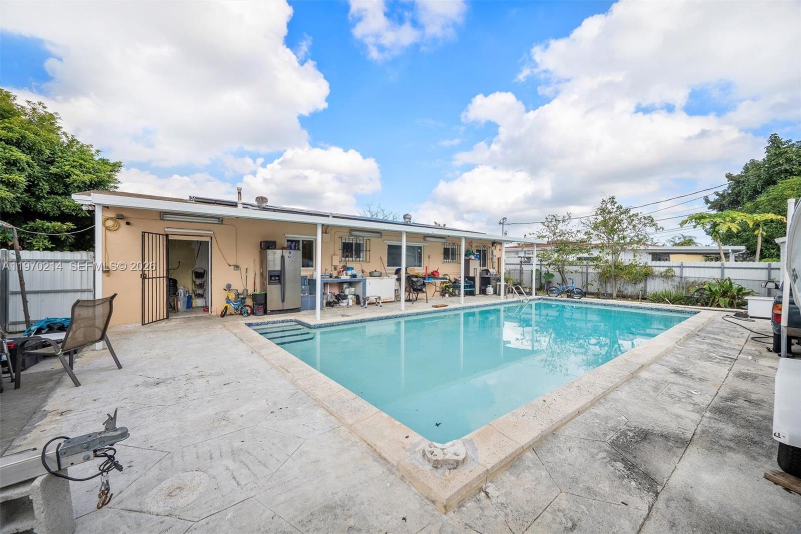 590 West 35th Place Hialeah, FL 33012 - Photo 13 of 16 a view of a house with swimming pool and sitting area