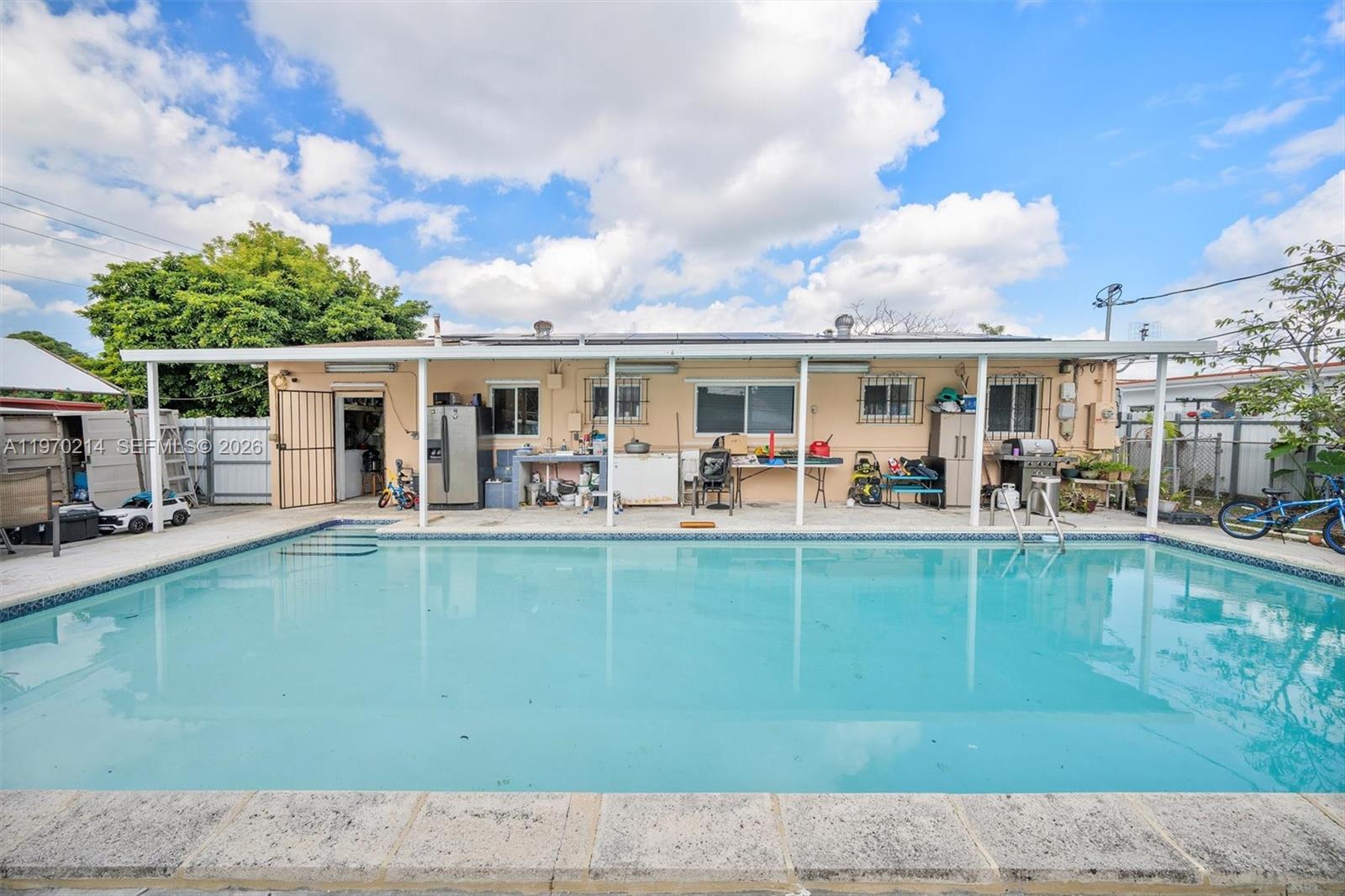 590 West 35th Place Hialeah, FL 33012 - Photo 15 of 16 a view of a swimming pool with outdoor seating