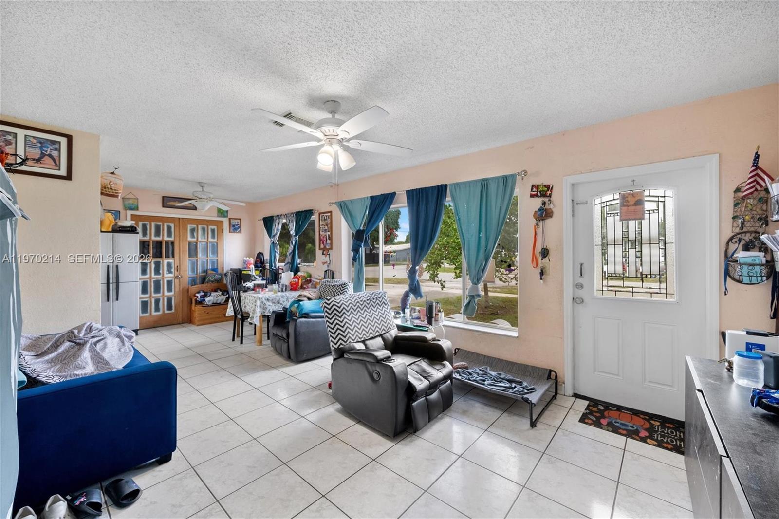 590 West 35th Place Hialeah, FL 33012 - Photo 2 of 16 a living room with furniture and a large window