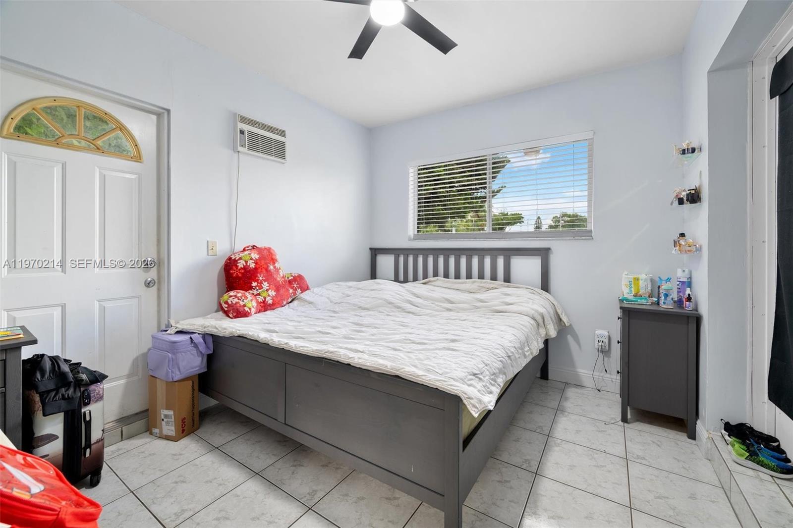 590 West 35th Place Hialeah, FL 33012 - Photo 6 of 16 a bedroom with a bed and a chandelier