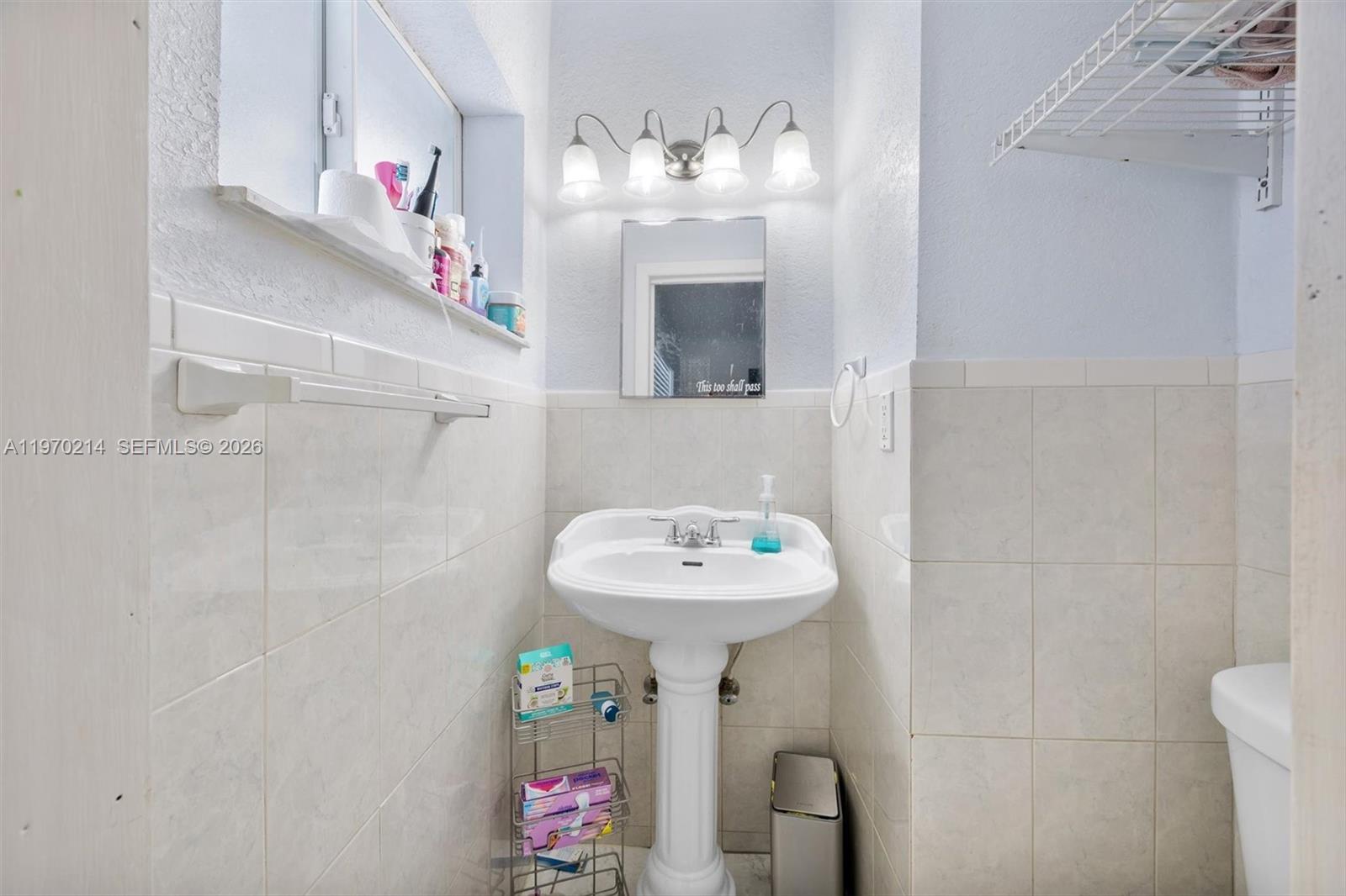 590 West 35th Place Hialeah, FL 33012 - Photo 10 of 16 a bathroom with a sink a mirror and a shower