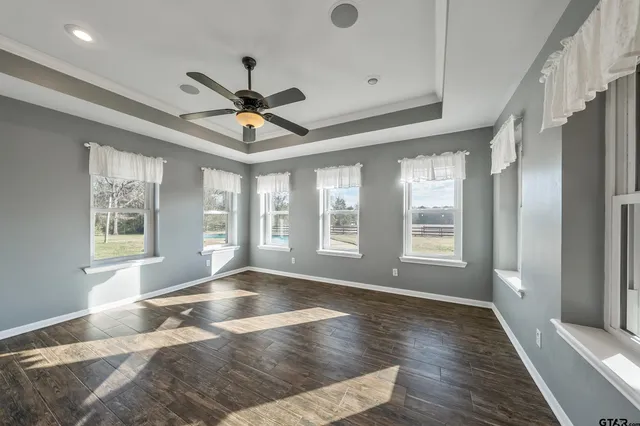 a view of a livingroom with a ceiling fan and window