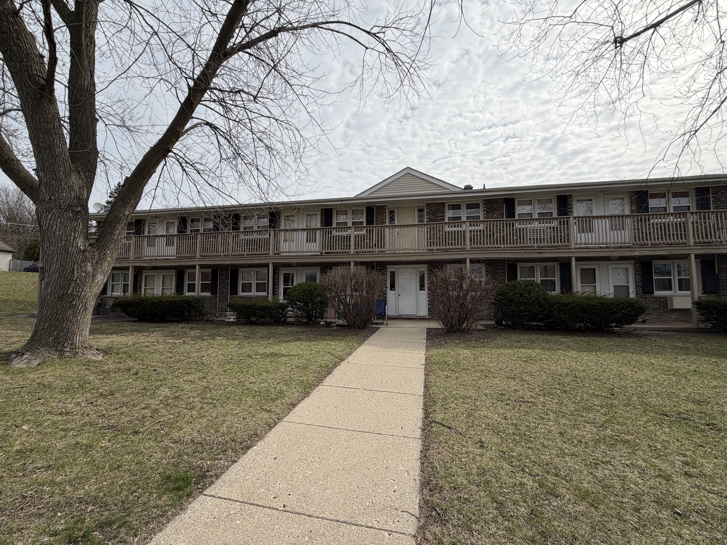 75 Willard Avenue, Unit 4 Elgin, IL 60120 - Photo 2 of 18 a front view of a house with a garden