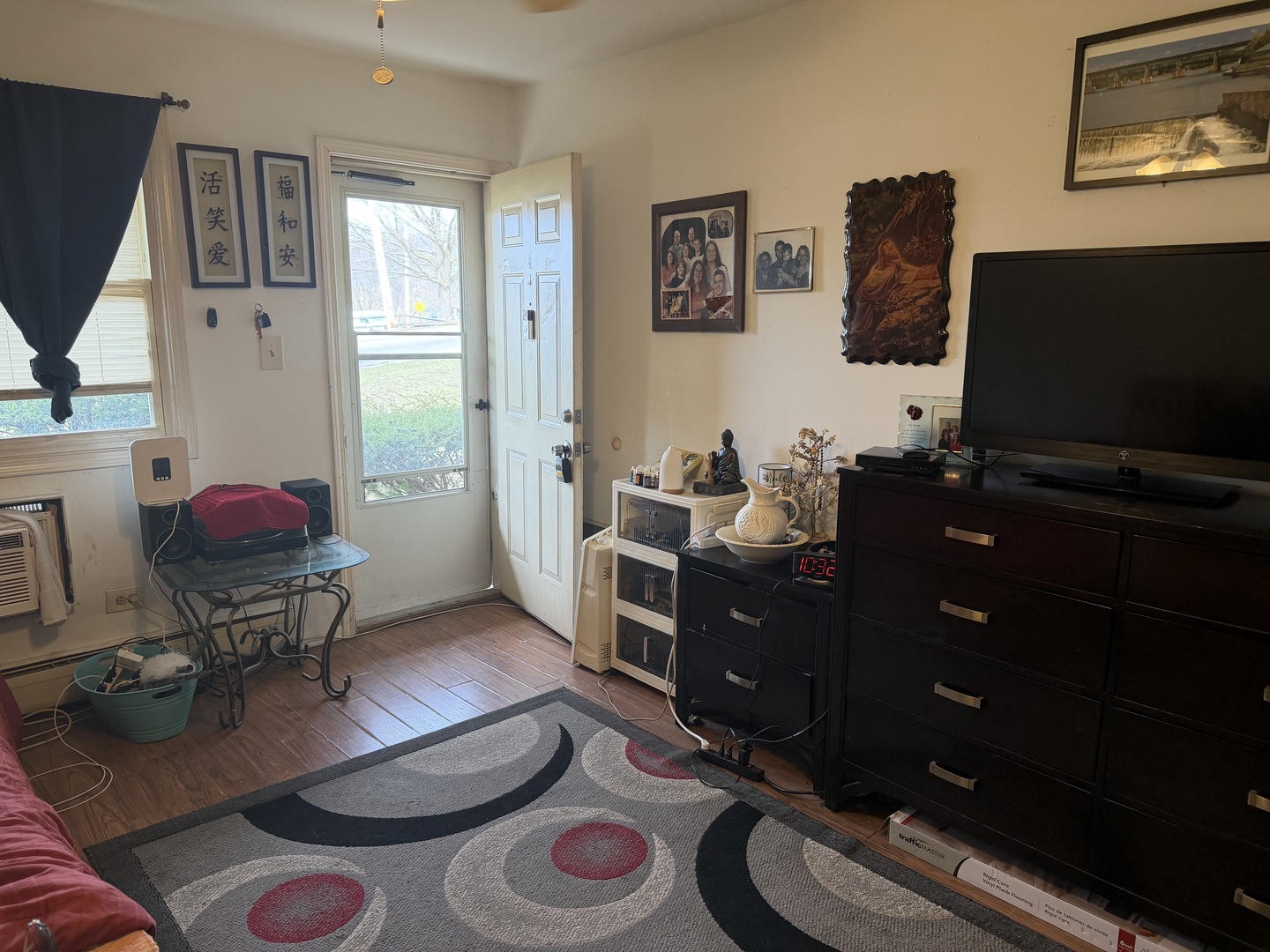 75 Willard Avenue, Unit 4 Elgin, IL 60120 - Photo 5 of 18 a living room with furniture and a flat screen tv