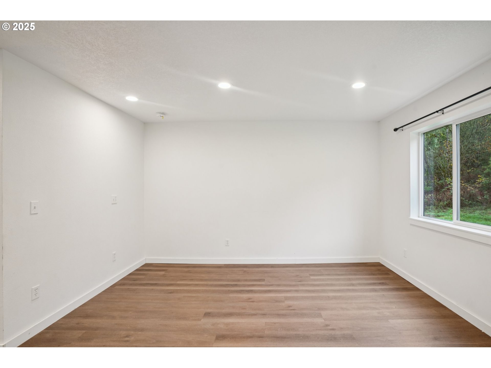 111 Finn Hall Road Woodland, WA 98674 - Photo 13 of 47 a view of an empty room with wooden floor and a window