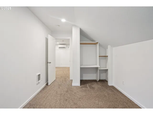 a bathroom with a toilet sink vanity and mirror