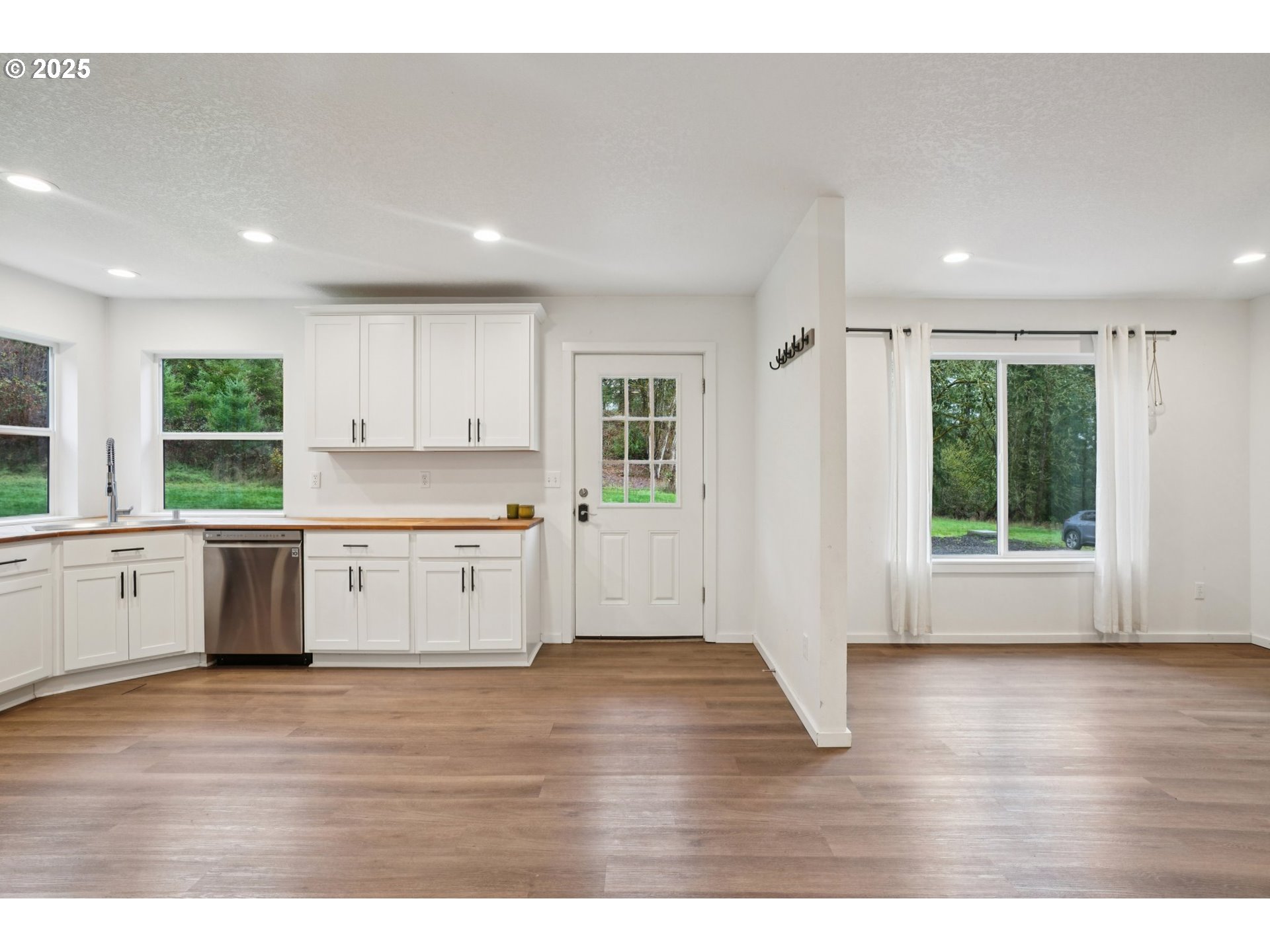 111 Finn Hall Road Woodland, WA 98674 - Photo 3 of 47 a view of an empty room with wooden floor and a window