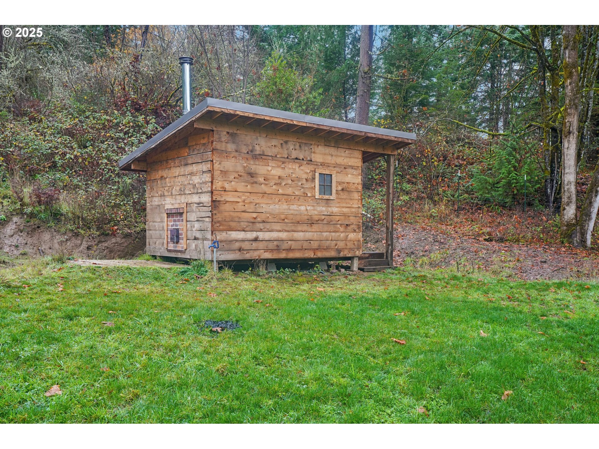 111 Finn Hall Road Woodland, WA 98674 - Photo 36 of 47 a view of a backyard with barn and large trees