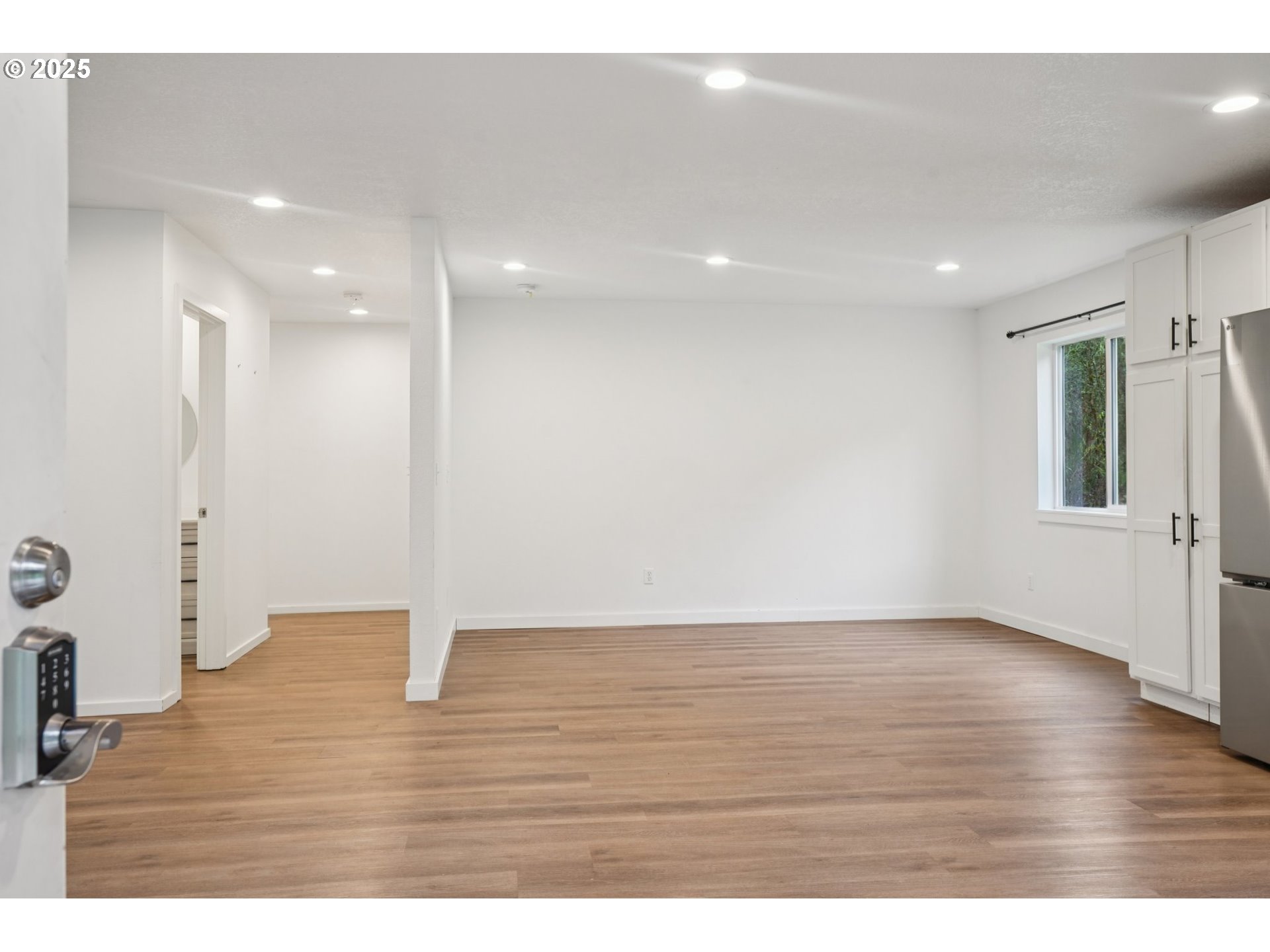 111 Finn Hall Road Woodland, WA 98674 - Photo 4 of 47 a view of an empty room with wooden floor