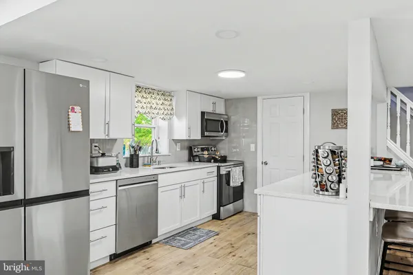 a kitchen with a sink a stove cabinets and refrigerator