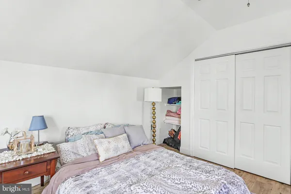a bedroom with a bed and a lamp