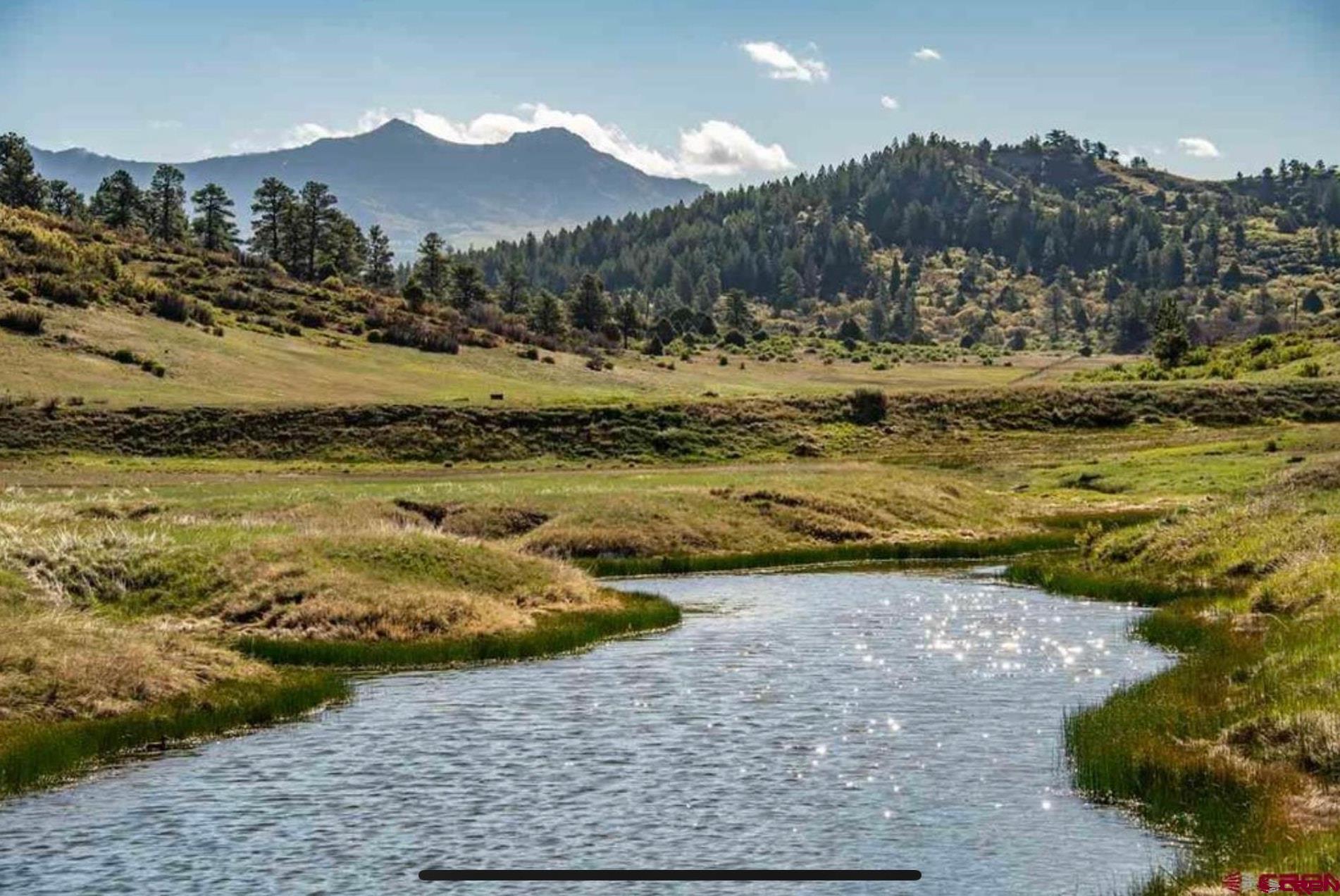 265 Spring Creek Circle Chromo, CO 81128 - Photo 1 of 13 a view of a lake with a mountain