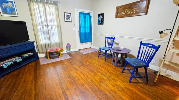 a living room with furniture and a flat screen tv