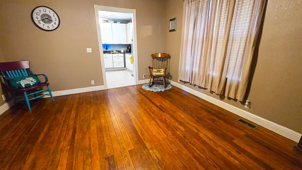 a view of a room with wooden floor and a chair
