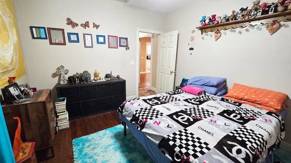 a bedroom with a bed and a dresser in it
