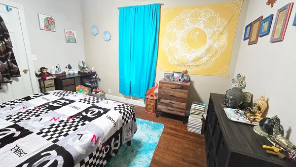 a bedroom with furniture and a wooden floor