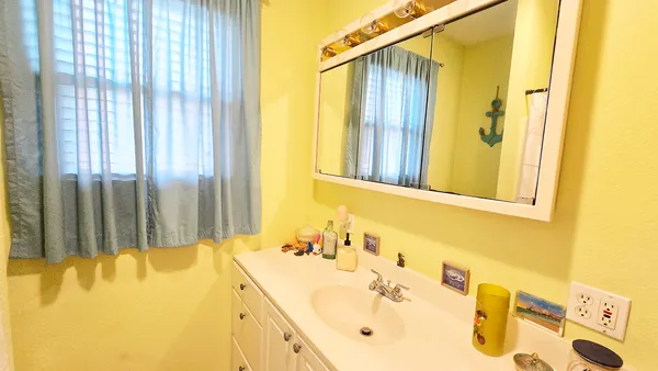 a bathroom with a tub sink and mirror