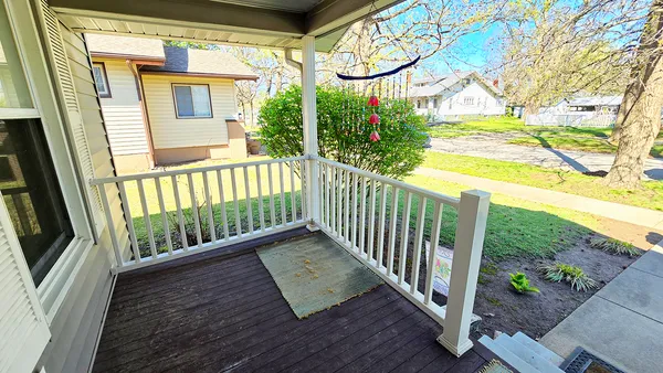 a view of a porch with wooden floor and fence