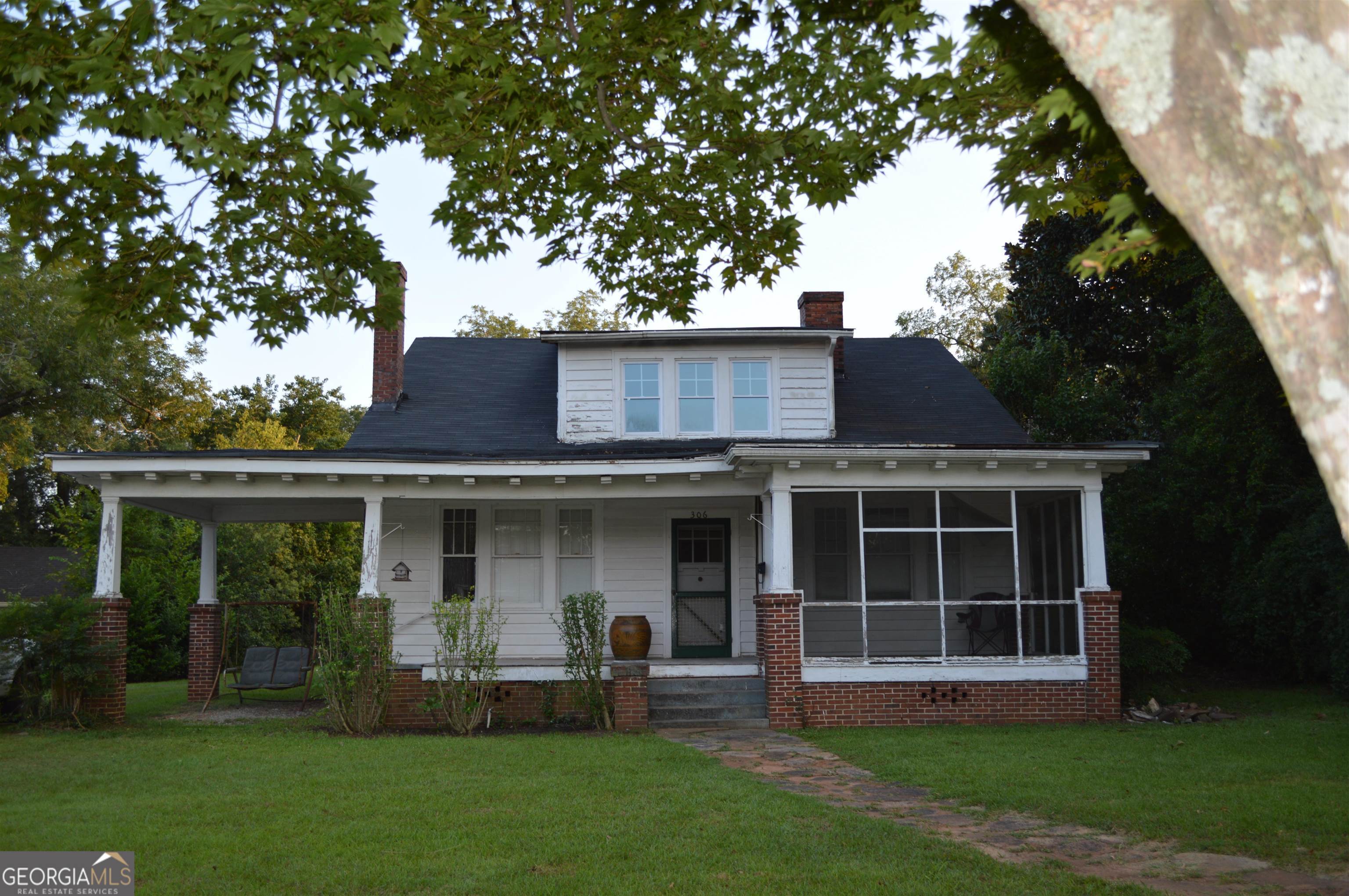 a large tree in front of a house