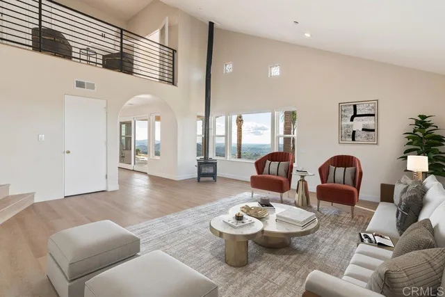 a view of a room with wooden floor fan and windows