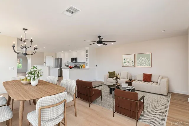 a view of a white house with a large window and wooden fence