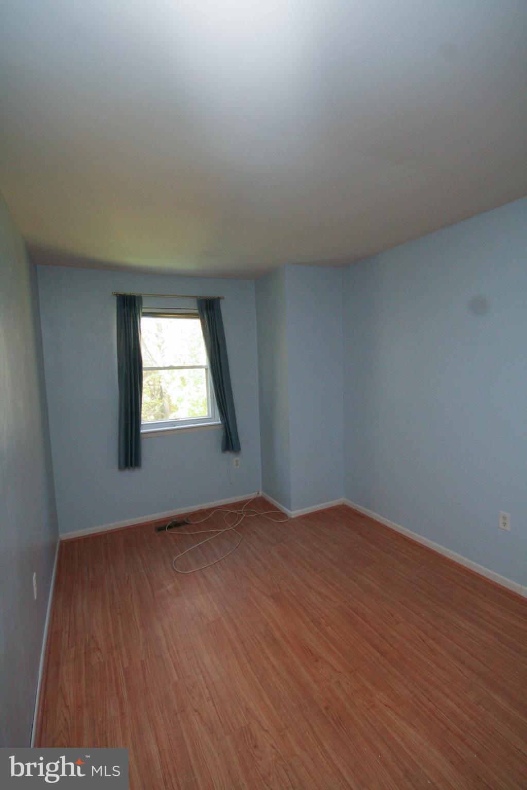 9352 Pan Ridge Road Baltimore, MD 21234 - Photo 22 of 30 an empty room with wooden floor and windows
