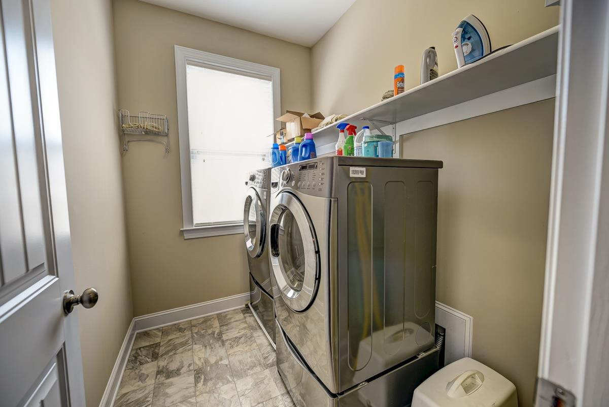 1212 Barnford Mill Road Wake Forest, NC 27587 - Photo 22 of 30 Laundry Room has shelving, window, iron holder and vinyl flooring. Laundry Room