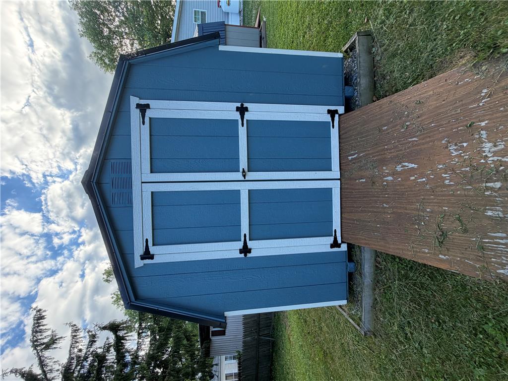 12 Springridge Road Bath, PA 18014 - Photo 37 of 61 A quaint blue storage shed offers ample space for tools and outdoor equipment.