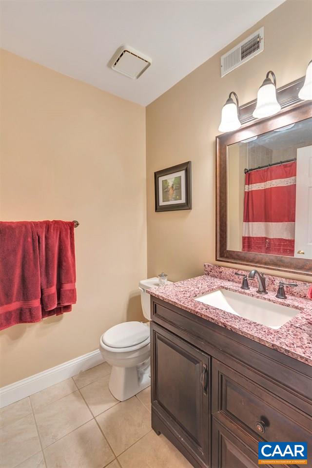 1065 Hunters Ridge Road Earlysville, VA 22936 - Photo 15 of 27 a bathroom with a granite countertop sink a mirror and a toilet