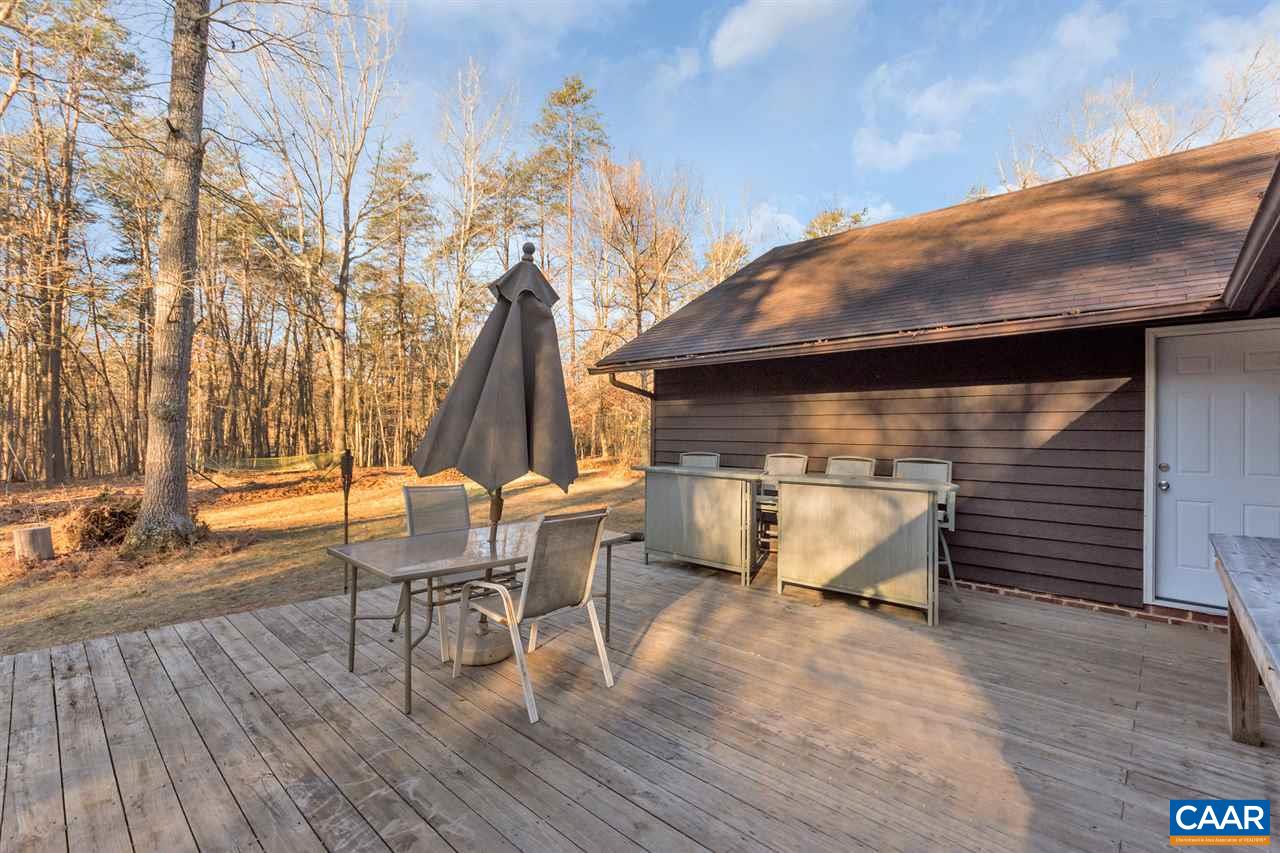 1065 Hunters Ridge Road Earlysville, VA 22936 - Photo 20 of 27 a view of a patio with table and chairs with wooden floor and fence