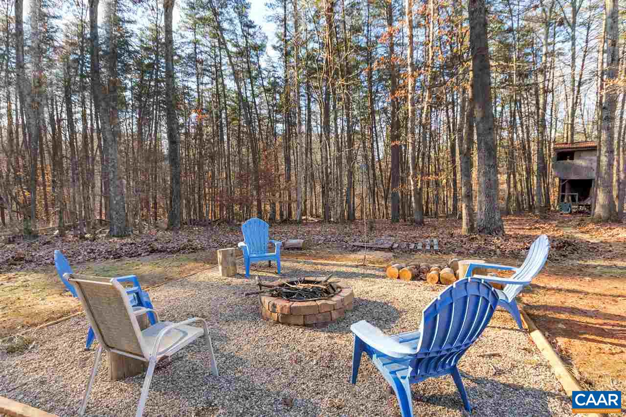 1065 Hunters Ridge Road Earlysville, VA 22936 - Photo 22 of 27 a view of a chairs and tables in the patio