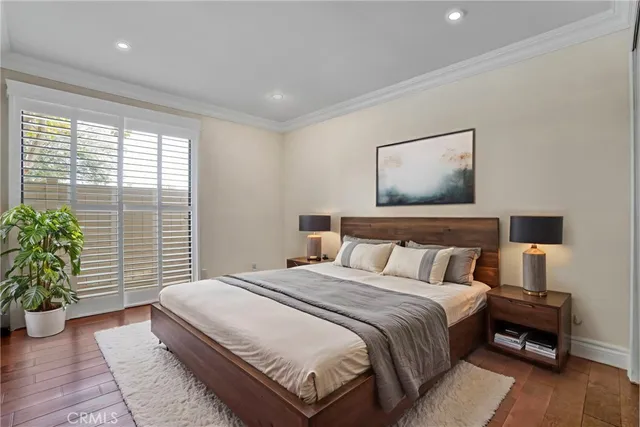 a view of a porch with a floor to ceiling window and potted plants