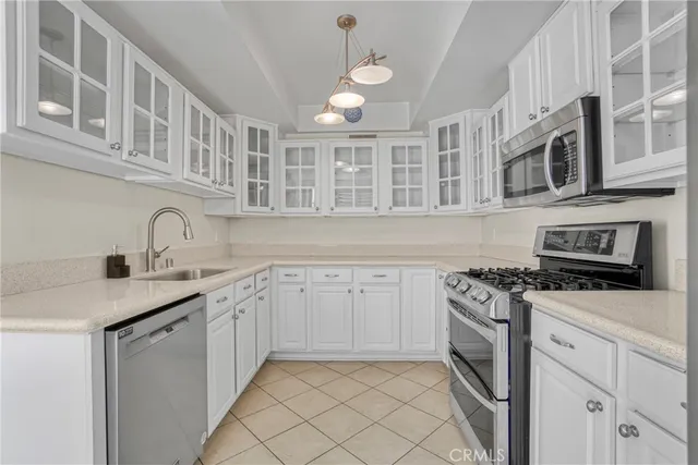 a kitchen with a sink stainless steel appliances and cabinets