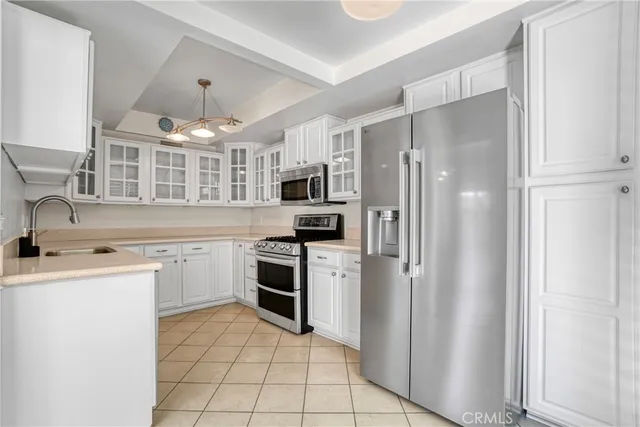 a kitchen with stainless steel appliances granite countertop a refrigerator stove and sink