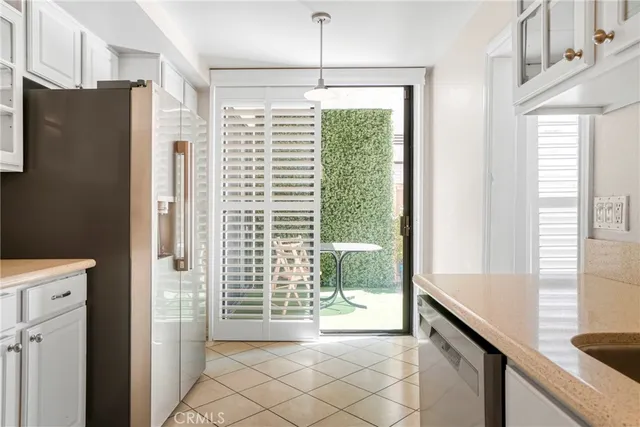a dining room with furniture a chandelier and wooden floor