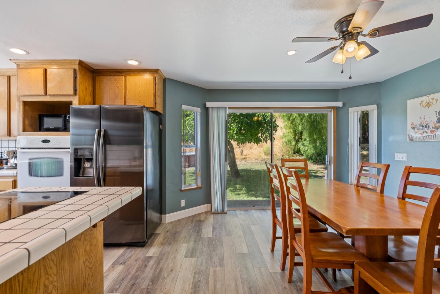 695 Hospital Road Hollister, CA 95023 - Photo 11 of 61 a kitchen with a table chairs refrigerator and microwave