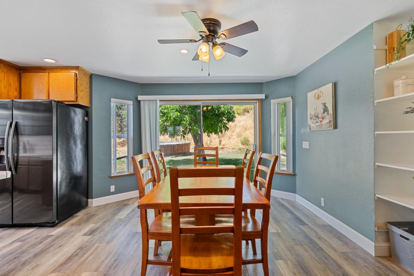 695 Hospital Road Hollister, CA 95023 - Photo 17 of 61 a dining room with furniture a chandelier and wooden floor