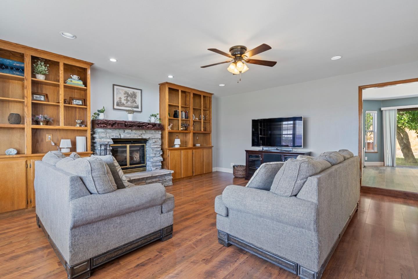 695 Hospital Road Hollister, CA 95023 - Photo 7 of 61 a living room with furniture a flat screen tv and a fireplace