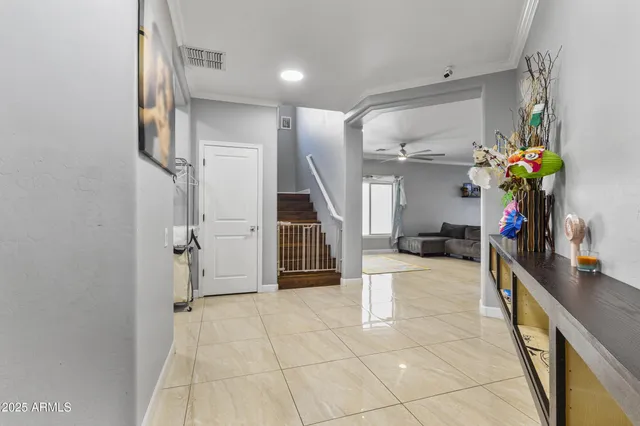 a view of a hallway with a dining table and chairs