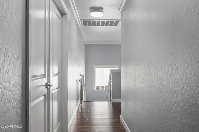 a view of a hallway with wooden floor