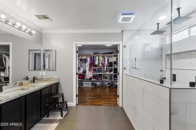 a bathroom with a sink shower and a mirror