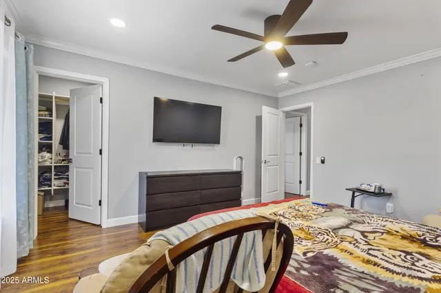 a bedroom with a bed and a flat screen tv