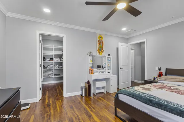 a bedroom with a bed and a view of kitchen