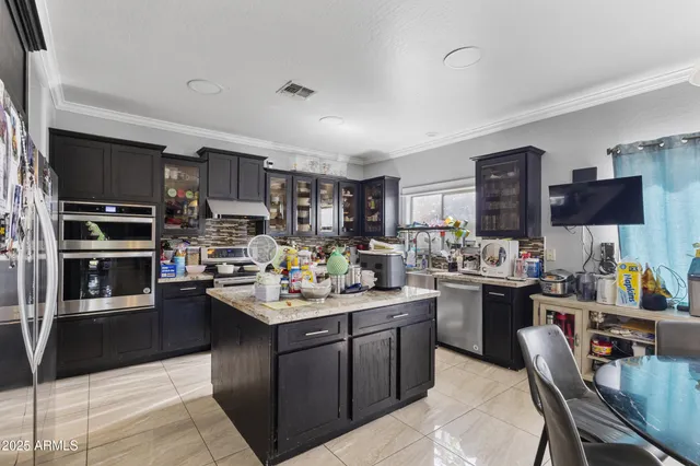 a kitchen with a sink stove and cabinets