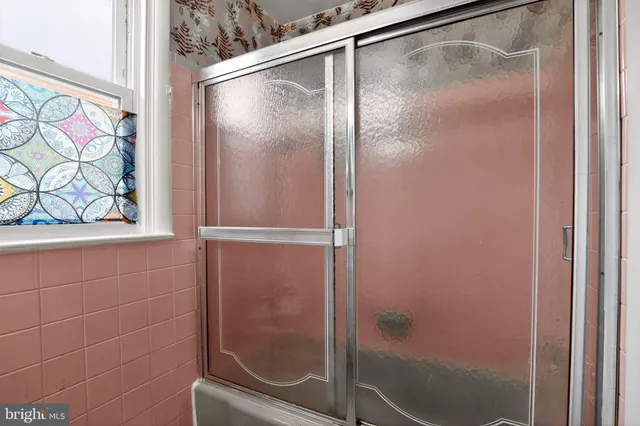 a bathroom with a glass shower door
